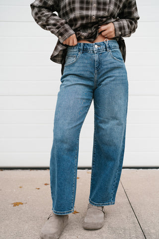 Front view of the Risen Peyton medium wash slouchy cropped barrel jeans with suede clogs