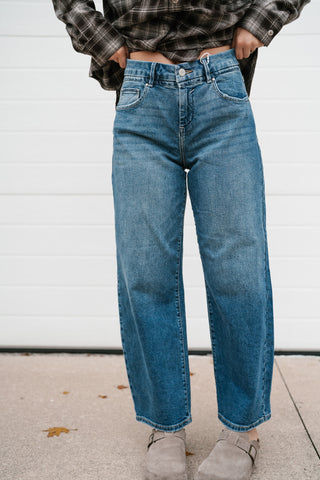 Front view of the medium wash cropped barrel jeans with five-pocket design
