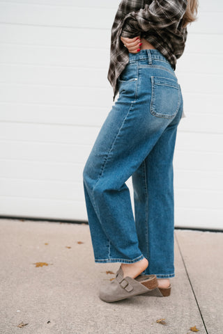 Side view of the slouchy barrel jeans showing the curved leg shape and cropped length