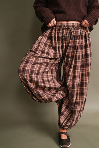 Harvest Moon Plaid Balloon Pants in brown and mauve plaid featuring a wide-leg balloon silhouette, elastic drawstring waist, and gathered ankle hems.