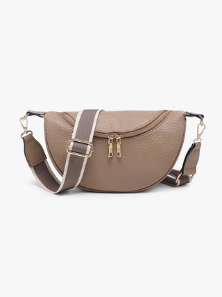 Taupe leather half-moon crossbody sling bag with adjustable striped shoulder strap and gold zipper.